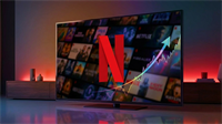 Netflix logo displayed on a flat-screen TV alongside an upward-trending stock price chart overlay.