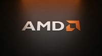 AMD logo displayed on a dark brushed-metal surface with the company's orange arrow icon.