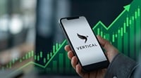 A hand holds a smartphone displaying the Vertical logo against a green upward-trending candlestick chart background.