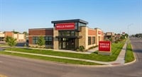 A Wells Fargo bank branch exterior featuring brick and stone construction on a suburban street corner.