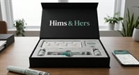 Hims & Hers branded weight loss kit open on a desk beside a smartphone displaying the Hims & Hers app.