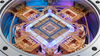 Close-up view of a quantum computing processor with copper wiring and a blue silicon chip.