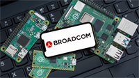 Broadcom logo displayed on a smartphone screen surrounded by Raspberry Pi circuit boards on a laptop keyboard.