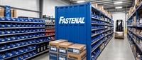 Warehouse aisle with Fastenal branded storage bins, boxes, and a forklift in a distribution center.
