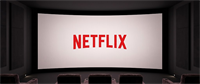 Netflix logo displayed on a large movie theater screen with empty seats in the foreground.