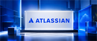 Atlassian logo displayed on an illuminated glass panel in a blue-lit setting with a cloud icon in the background.