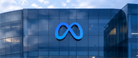 Meta's blue infinity logo displayed on the glass facade of a corporate office building.