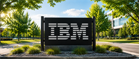 IBM logo displayed on an outdoor sign at a corporate campus entrance, surrounded by trees and landscaping.