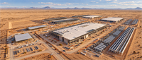 Aerial view of a large data center construction site with multiple buildings under development in a desert landscape.