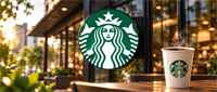 Starbucks logo sign mounted outside a storefront, with a coffee cup bearing the Starbucks logo on a table.