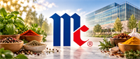 McCormick & Company logo displayed over bowls of spices and herbs with a glass office building in the background.