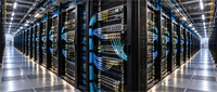 Rows of server racks with blue network cables in a data center housing computing infrastructure.