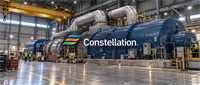 Large blue turbine generator equipment inside an industrial power plant facility with the Constellation Energy logo displayed.