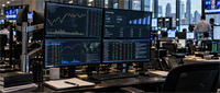 Multi-monitor trading desk displaying stock price charts, Q3 earnings data with EPS and revenue figures, and market data in an office.