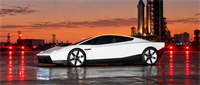 White Tesla sports car parked at a launch site with rocket boosters visible against a sunset sky.