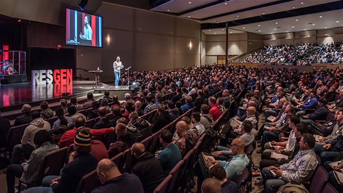 Crowd listen to keynote speaker at Restoration Generation Men's Summit