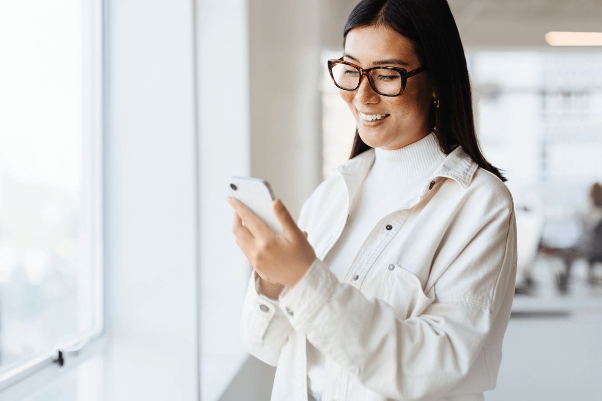 a woman holding her phone with MarketBeat watchlist