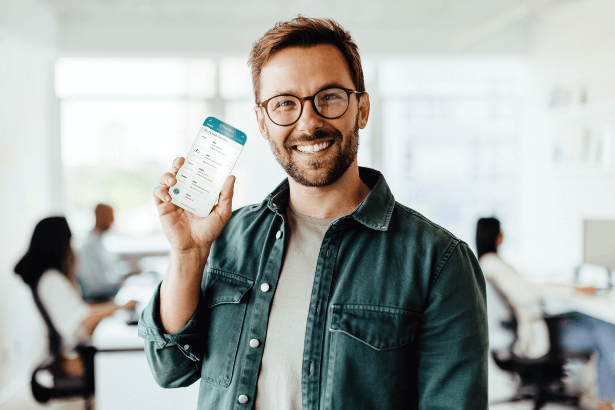 a man holding his phone with MarketBeat watchlist